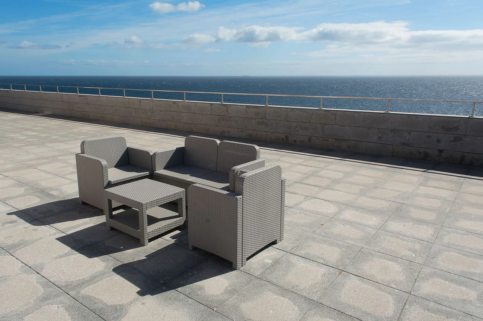 paver patio cost — interlocking pavers with contrasting border and seating area