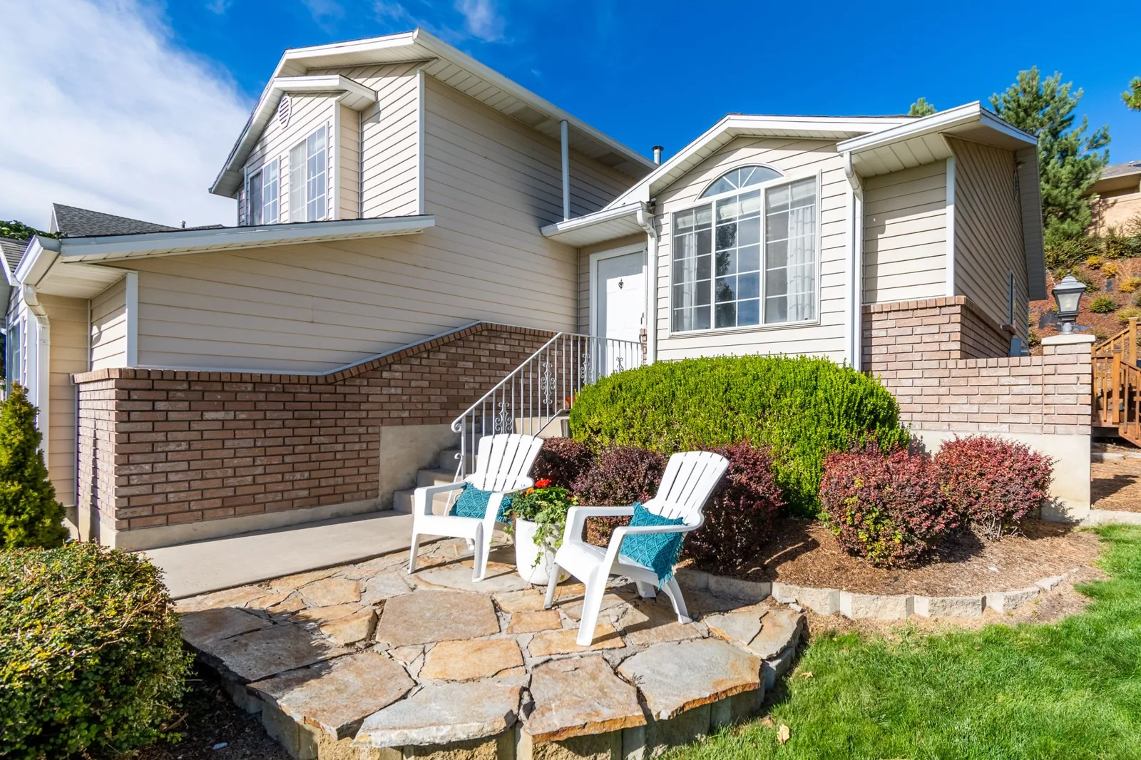 Front porch vs patio comparison showing a covered wood porch beside an open paver patio