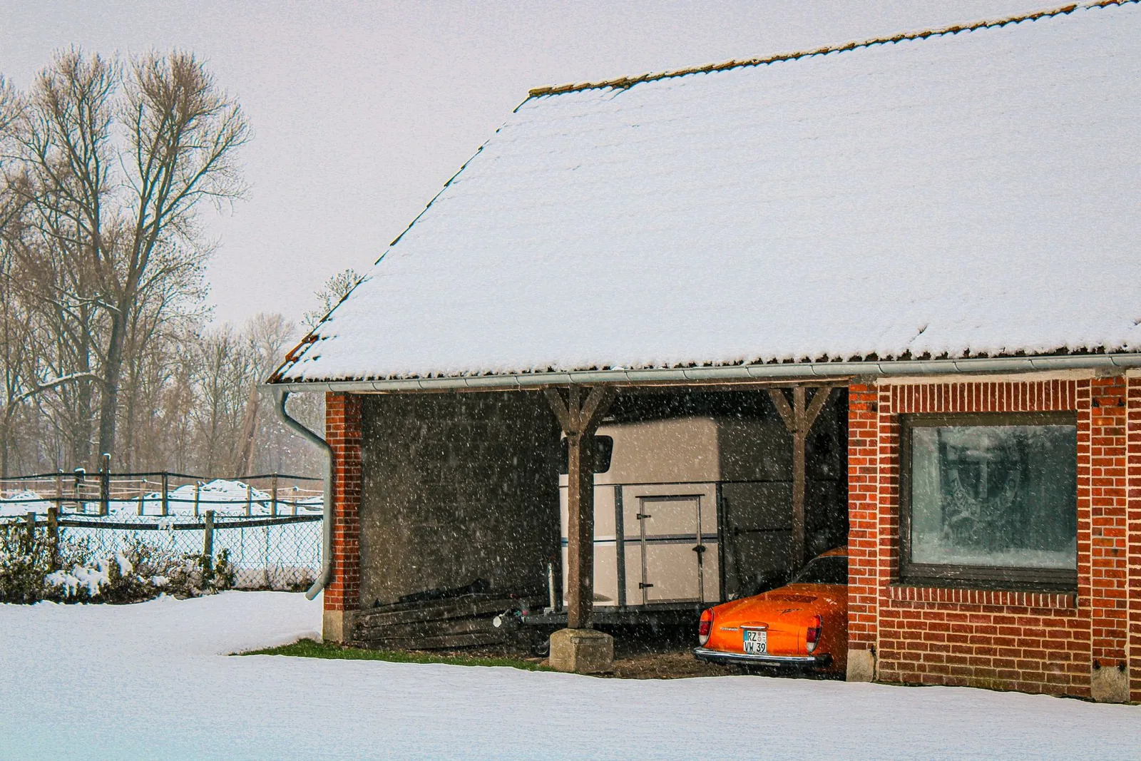 Detached garage with closed door and storage space