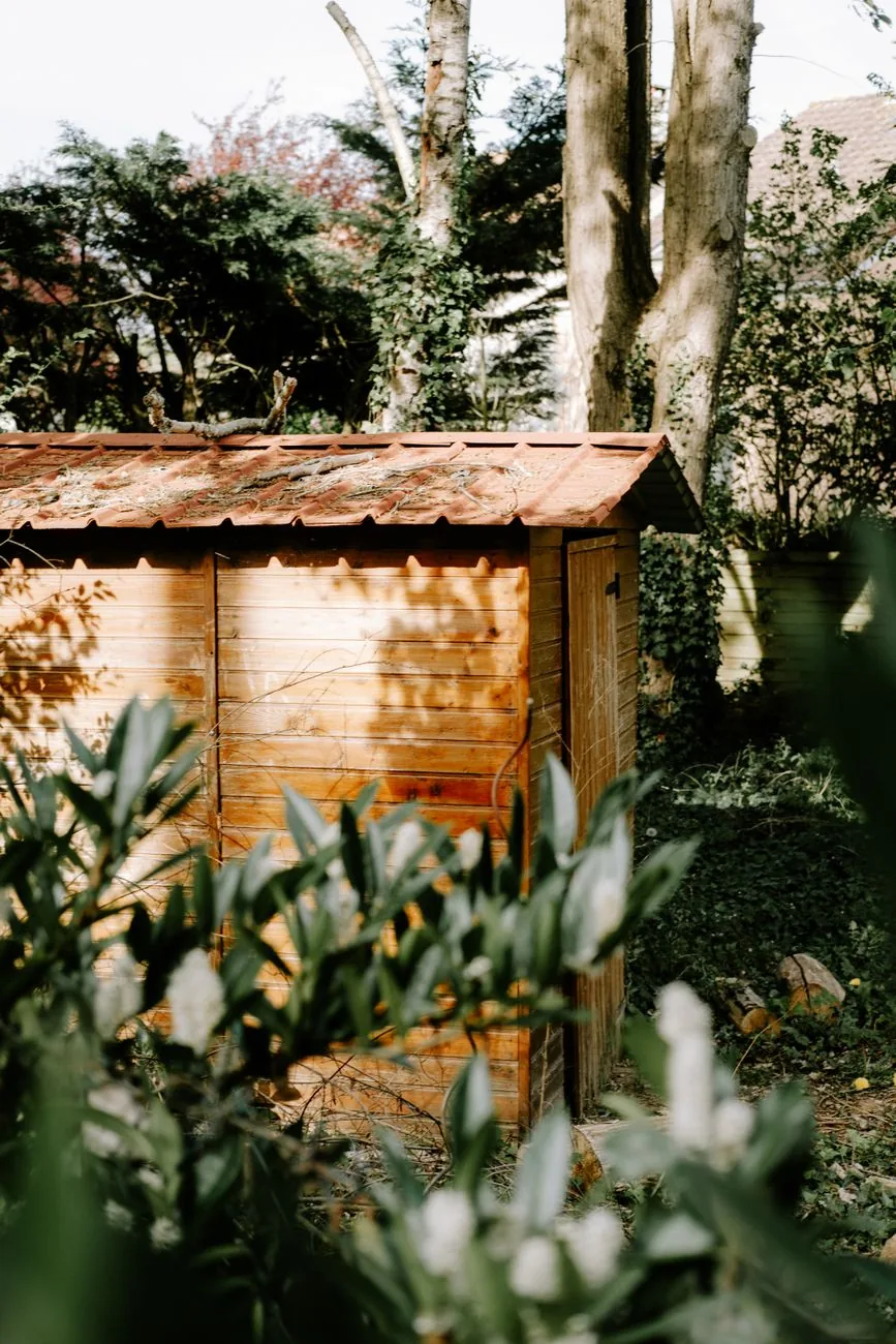 storage shed ideas — wood storage shed with double doors and matching house trim