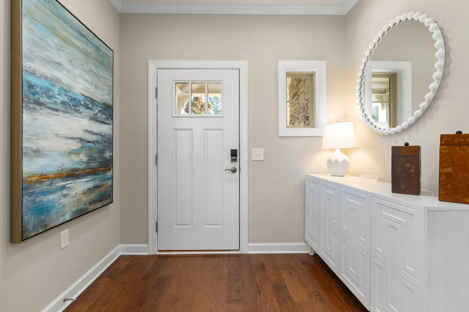 Layered entryway design with console, mirror, and rug