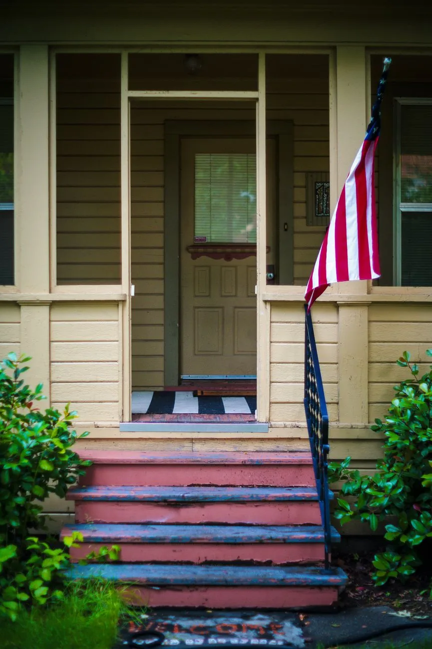 A covered front porch with composite decking costs more per square foot than an open stoop