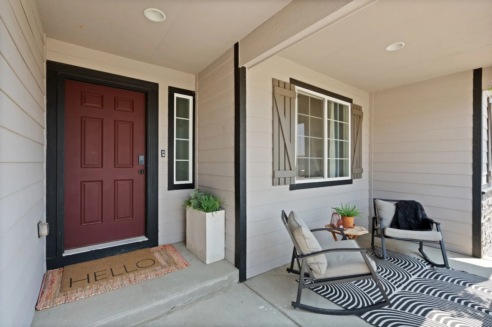 Covered back patio with outdoor seating and a fire pit